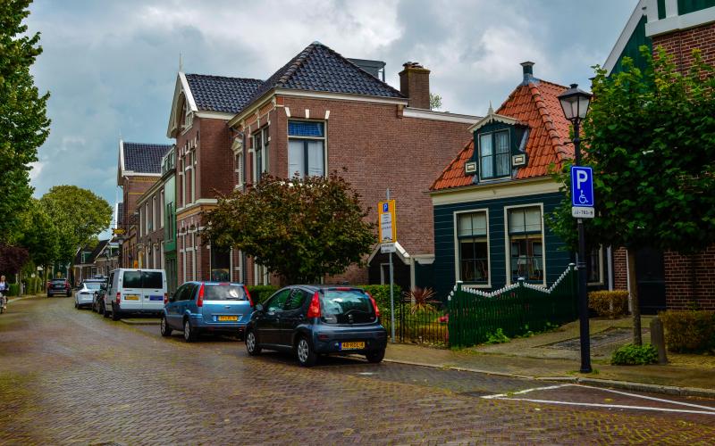 Een straat in Nederland met geparkeerde auto's