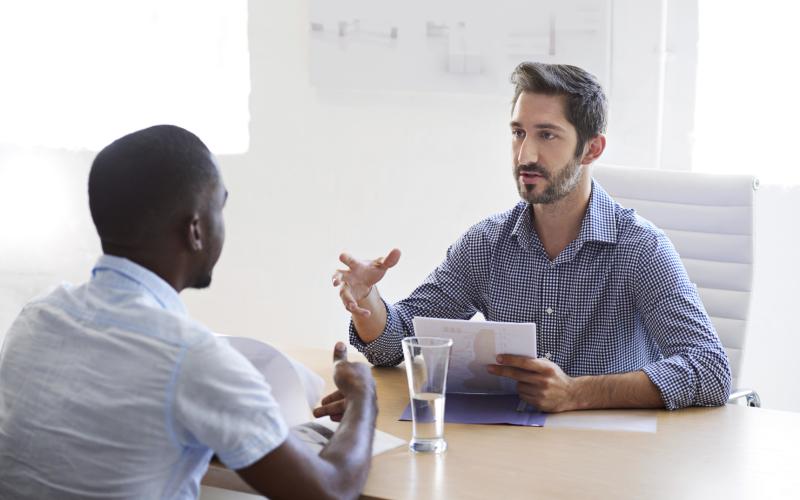 open office, two men are having a meeting