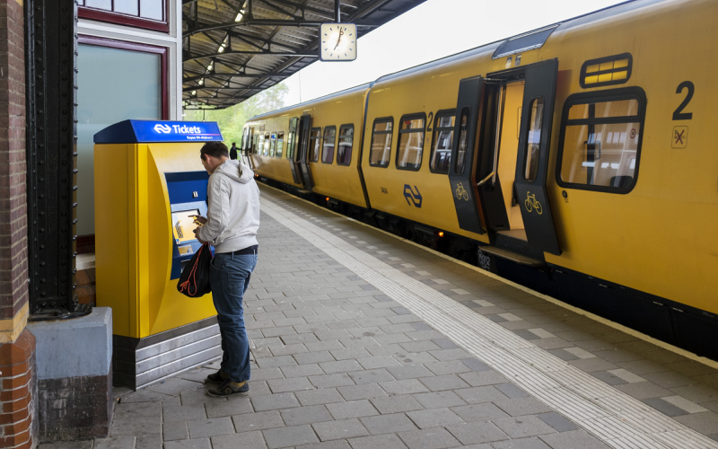 Man koopt treinkaartje op het station