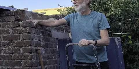 Man bij huismuur