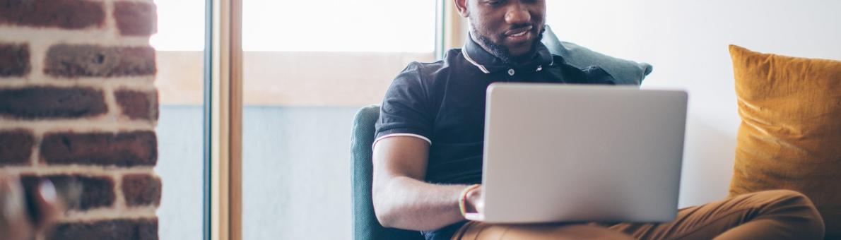 Man met laptop op schoot