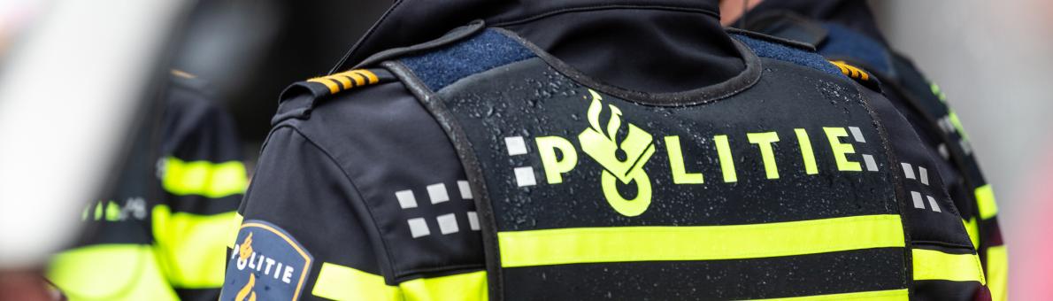 Politieuniform gezien op de rug Politieuniform gezien op de rug