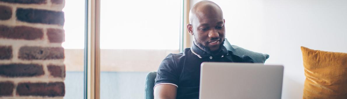 man met laptop op schoot