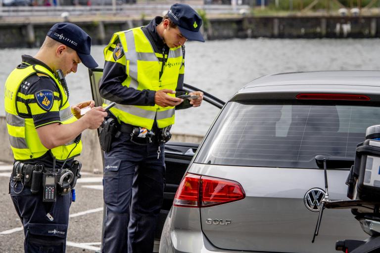 Politieagenten schrijven bekeuring uit bij auto
