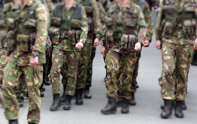 Marcherende militairen. Alleen hun benen zijn zichtbaar