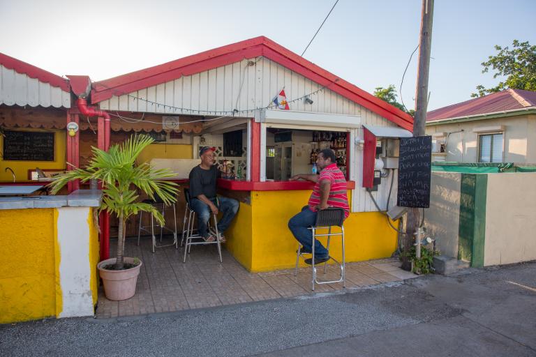 Two men sitting on the terrace at Statia